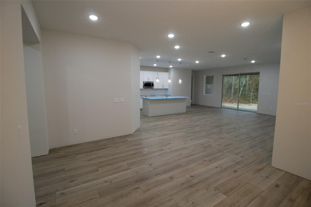 Empty room, Interior, Kitchen, Pendant Lights, Recessed Lighting, Stainless Steel Appliances, Wood Texture Flooring