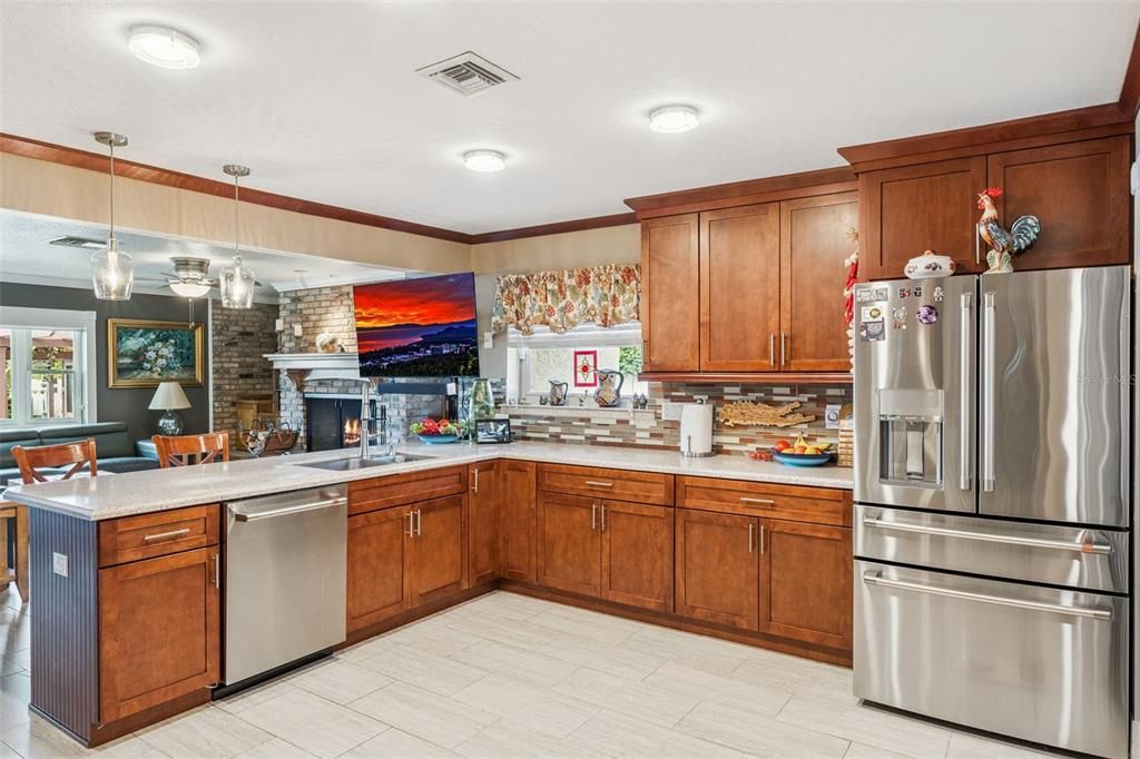 Dining room, Fireplace, Interior, Kitchen, Pendant Lights, Stainless Steel Appliances, Stone Walls, Wood Texture Flooring