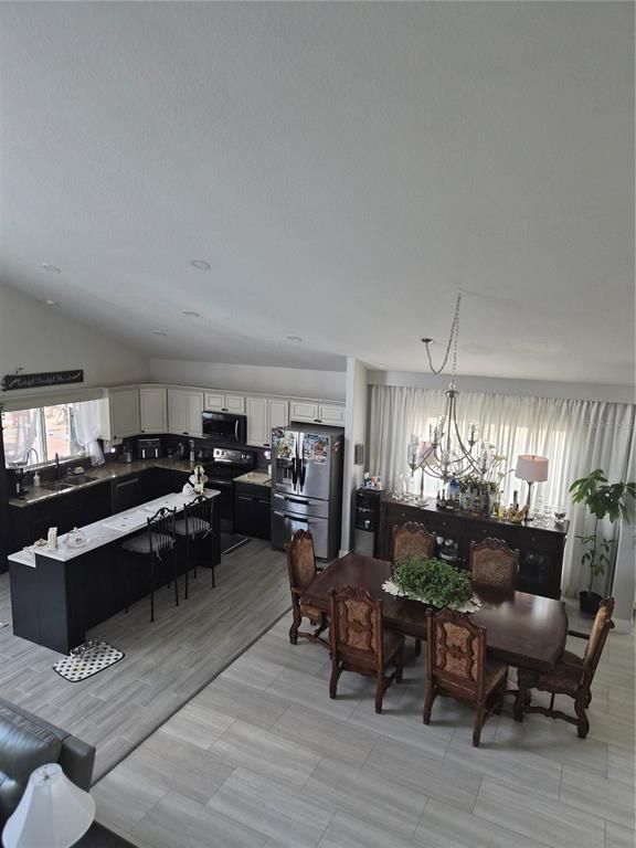 Chandelier, Dining room, Interior, Kitchen, Living room, Pendant Lights, Recessed Lighting, Stainless Steel Appliances, Wood Texture Flooring