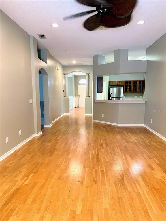 Empty room, Interior, Kitchen, Recessed Lighting, Stainless Steel Appliances, Wood Texture Flooring