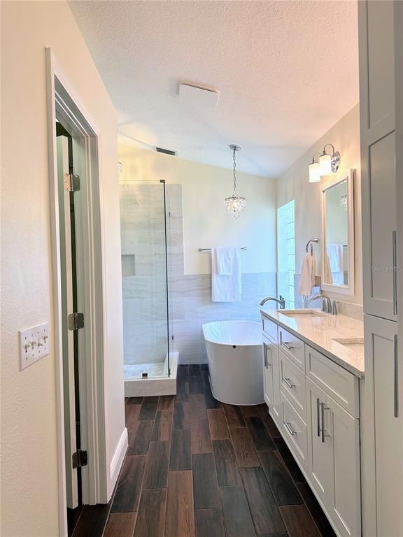 Bathroom, Chandelier, Dual Sink Vanities, Free Standing Baths, Glass Shower, Interior, Wood Texture Flooring