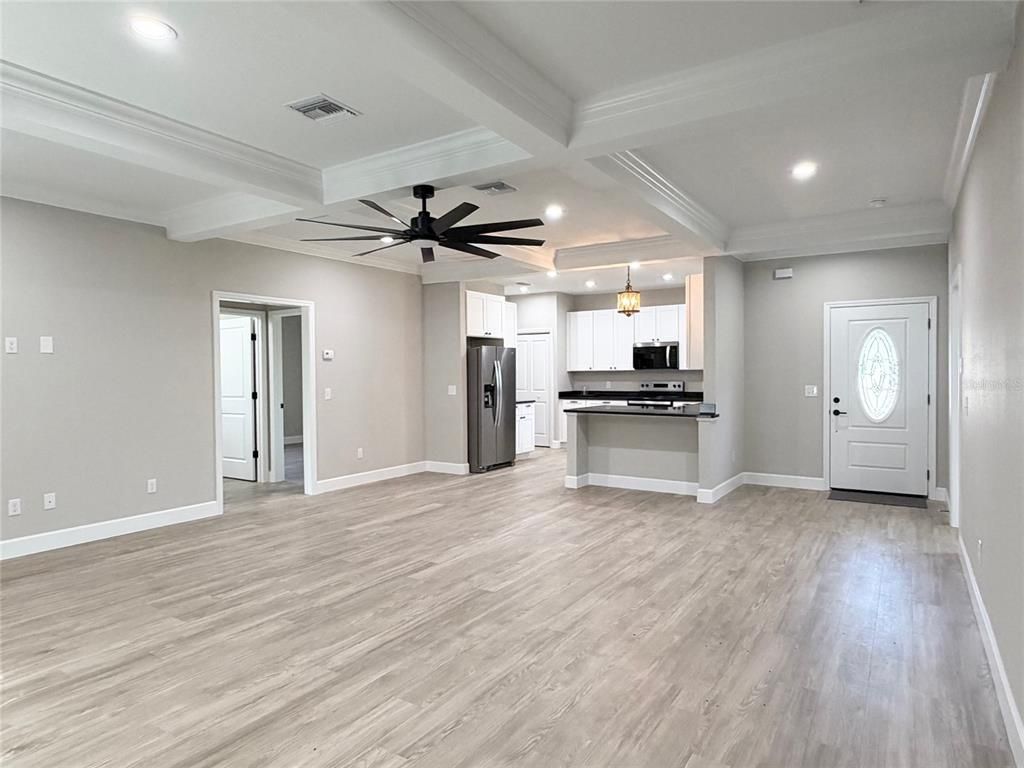 Empty room, Interior, Kitchen, Recessed Lighting, Stainless Steel Appliances, Wood Texture Flooring