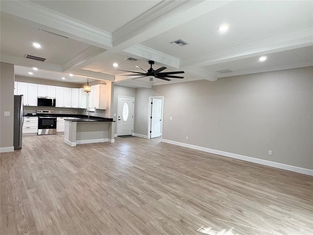 Empty room, Interior, Kitchen, Pendant Lights, Recessed Lighting, Stainless Steel Appliances, Wood Texture Flooring