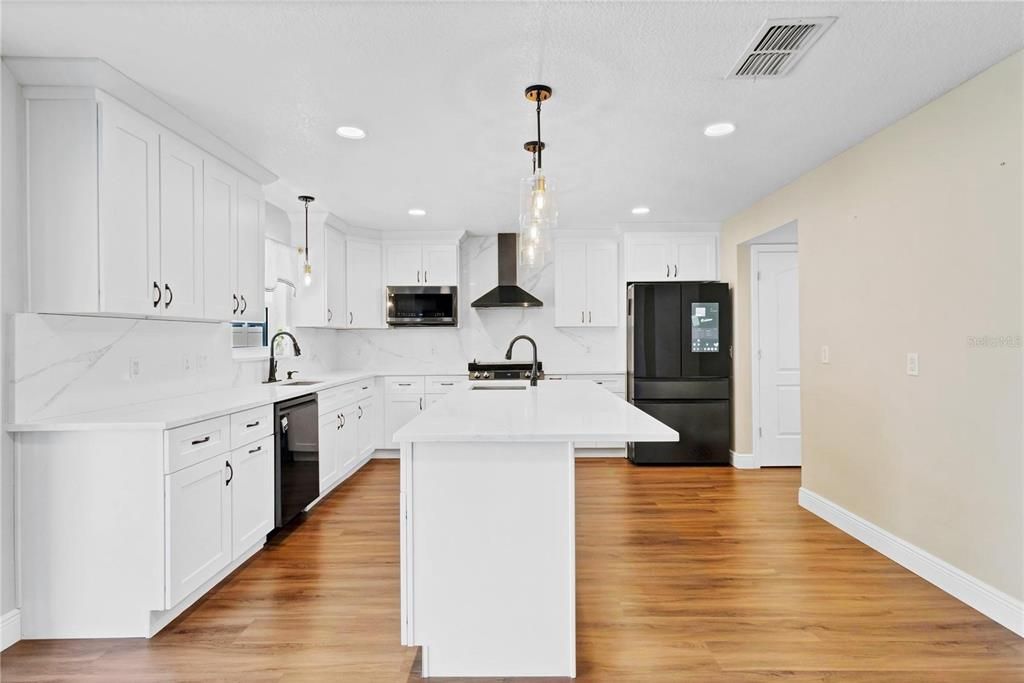 Interior, Kitchen, Marble Walls, Pendant Lights, Recessed Lighting, Stainless Steel Appliances, Wood Texture Flooring