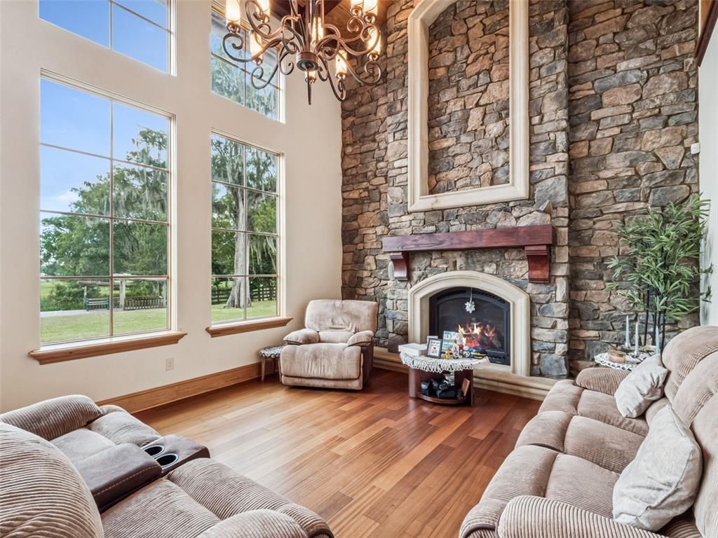 Chandelier, Fireplace, Interior, Living room, Stone Walls, Wood Texture Flooring