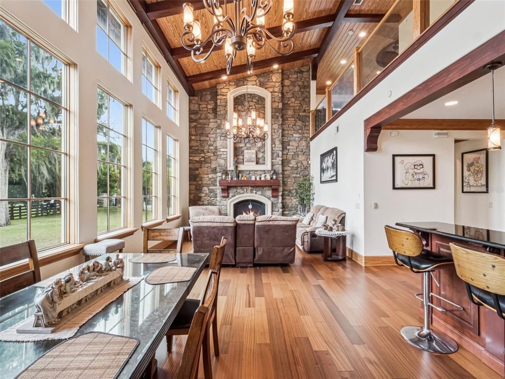 Chandelier, Dining room, Fireplace, Interior, Living room, Recessed Lighting, Stone Walls, Wooden Beams, Wooden Ceilings, Wood Texture Flooring