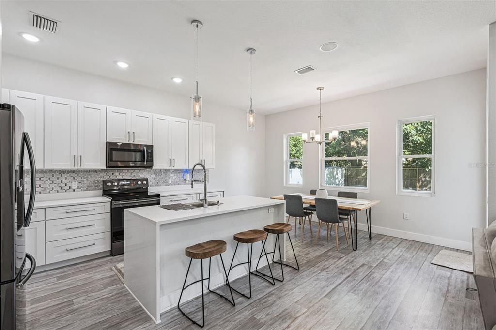 Dining room, Interior, Kitchen, Pendant Lights, Recessed Lighting, Stainless Steel Appliances, Wood Texture Flooring