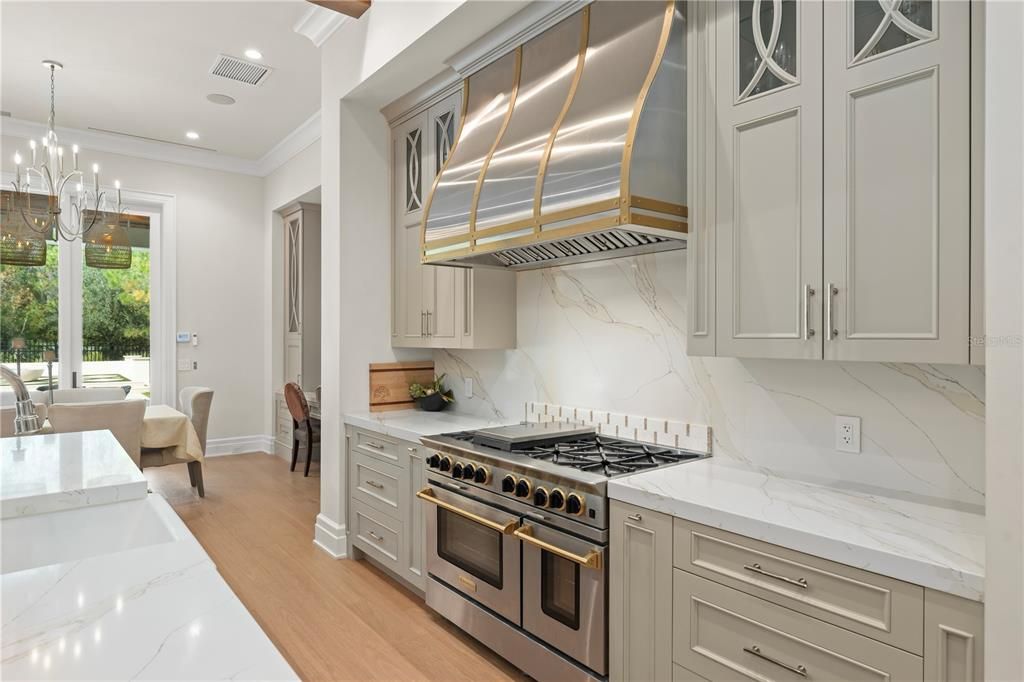 Chandelier, Interior, Kitchen, Marble Walls, Pendant Lights, Recessed Lighting, Stainless Steel Appliances, Wood Texture Flooring