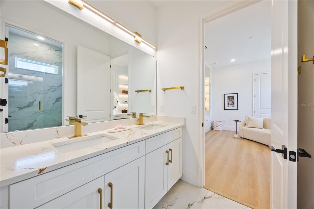 Bathroom, Dual Sink Vanities, Interior, Marble, Marble Walls, Recessed Lighting, Wood Texture Flooring