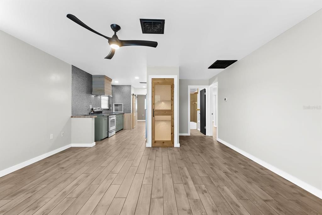Empty room, Interior, Kitchen, Recessed Lighting, Stainless Steel Appliances, Wood Texture Flooring