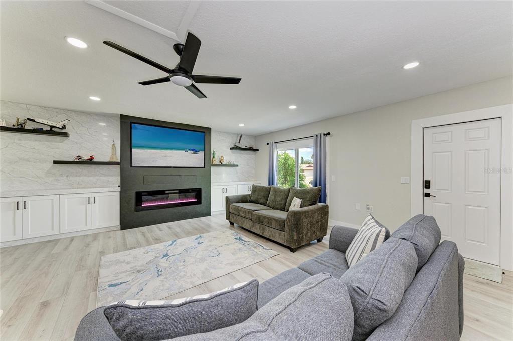 Fireplace, Interior, Living room, Marble Walls, Recessed Lighting, Wood Texture Flooring