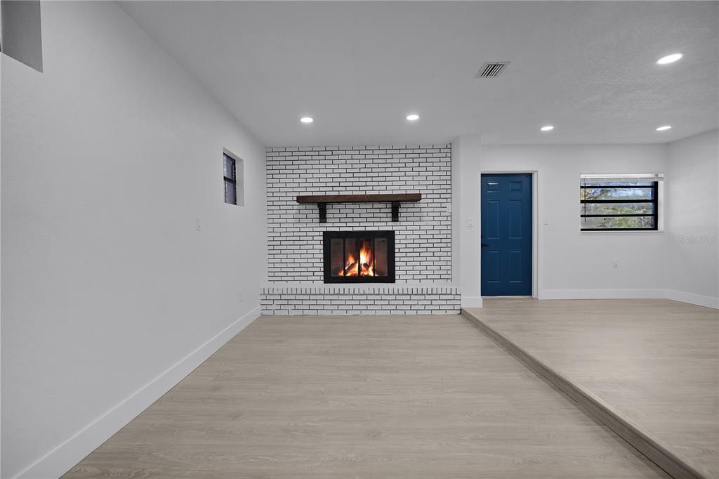 Empty room, Fireplace, Interior, Recessed Lighting, Stone Walls, Wood Texture Flooring