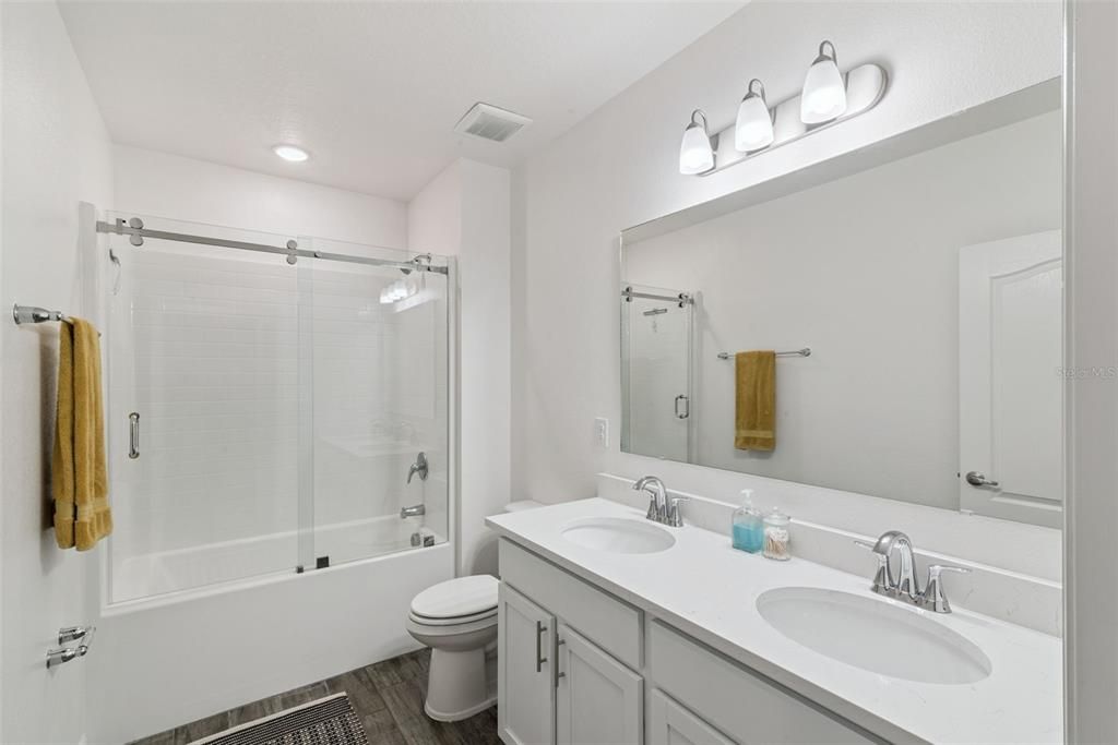 Bathroom, Dual Sink Vanities, Glass Shower, Interior, Recessed Lighting, Wood Texture Flooring