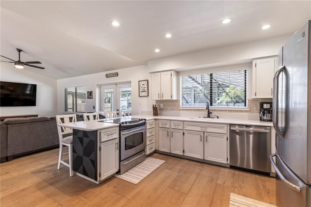 Dining room, Interior, Kitchen, Living room, Recessed Lighting, Stainless Steel Appliances, Wood Texture Flooring