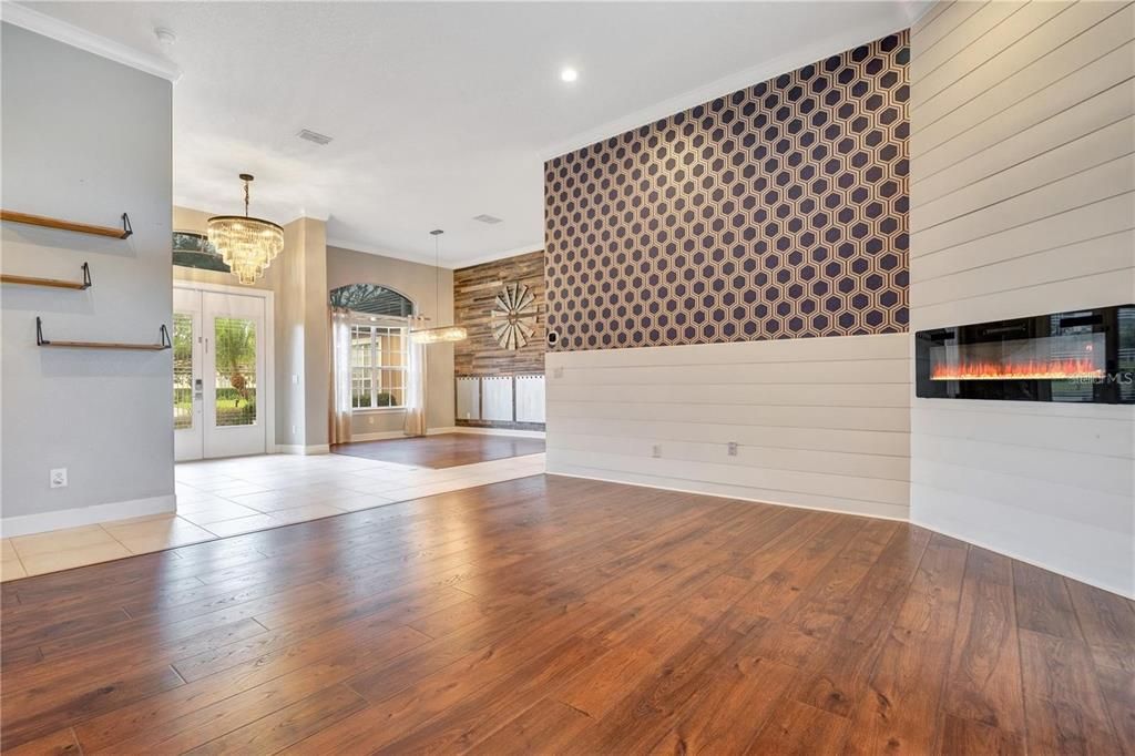Chandelier, Empty room, Fireplace, Interior, Pendant Lights, Recessed Lighting, Wood Texture Flooring