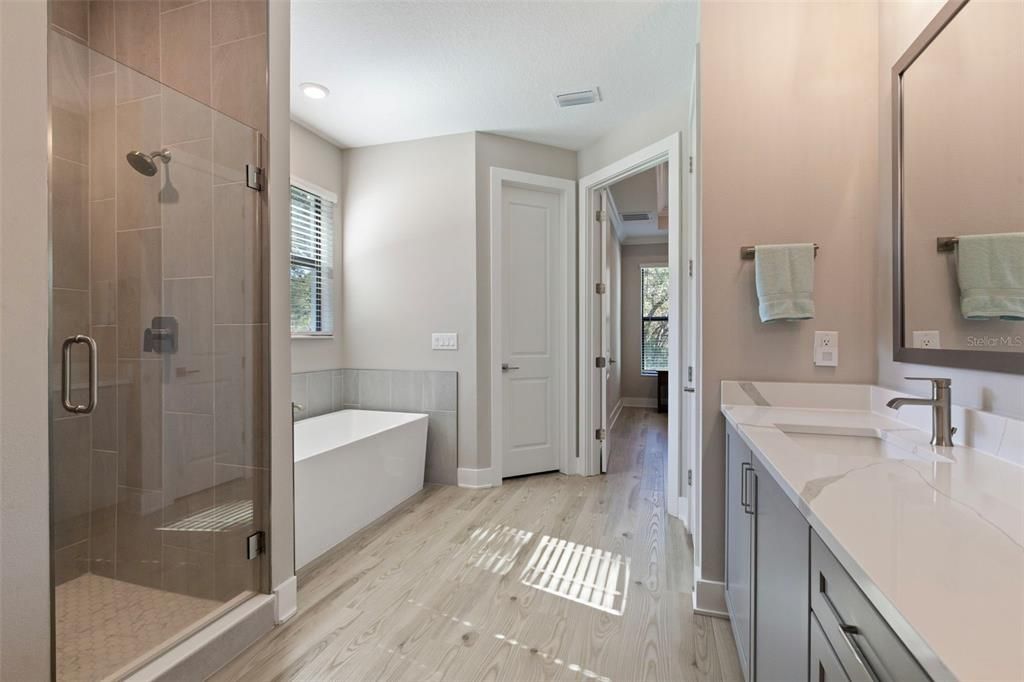 Bathroom, Dual Sink Vanities, Free Standing Baths, Glass Shower, Interior, Recessed Lighting, Wood Texture Flooring