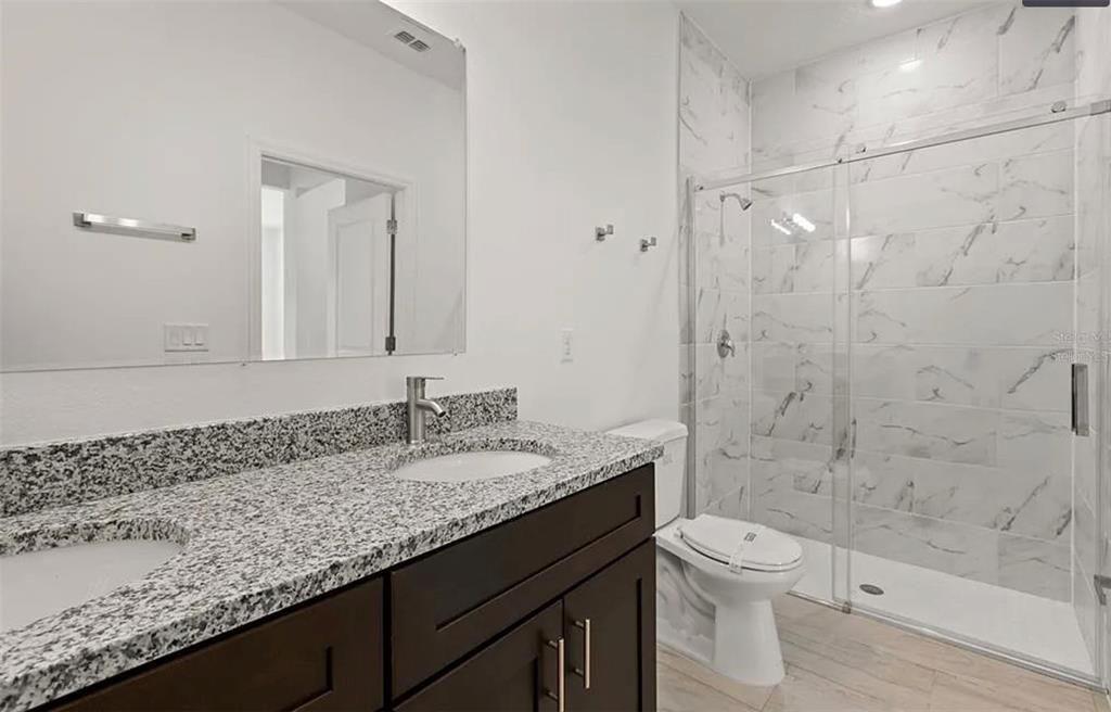 Bathroom, Dual Sink Vanities, Glass Shower, Interior, Marble Walls, Recessed Lighting