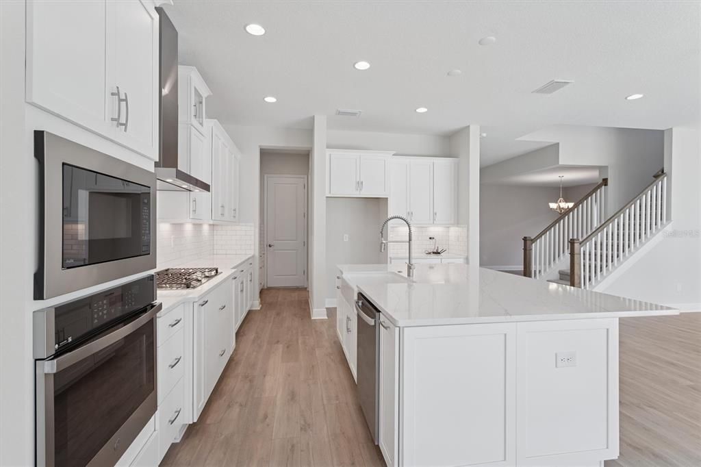 Chandelier, Interior, Kitchen, Pendant Lights, Recessed Lighting, Stainless Steel Appliances, Wood Texture Flooring