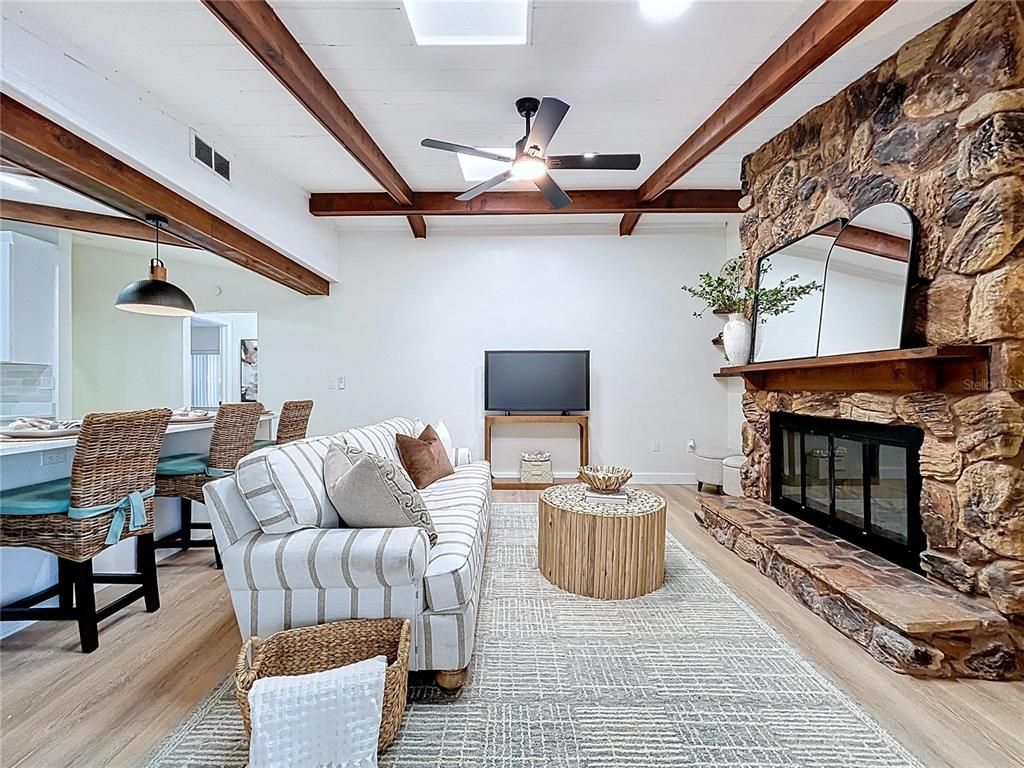 Dining room, Fireplace, Interior, Living room, Pendant Lights, Recessed Lighting, Stone Walls, Wooden Beams, Wood Texture Flooring