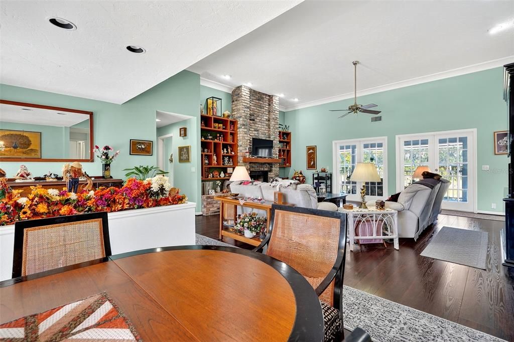 Dining room, Fireplace, Interior, Living room, Recessed Lighting, Stone Walls, Wood Texture Flooring