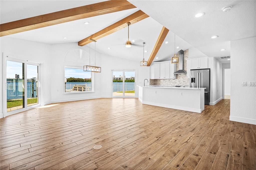 Empty room, Interior, Kitchen, Pendant Lights, Recessed Lighting, Stainless Steel Appliances, Water, Wooden Beams, Wood Texture Flooring