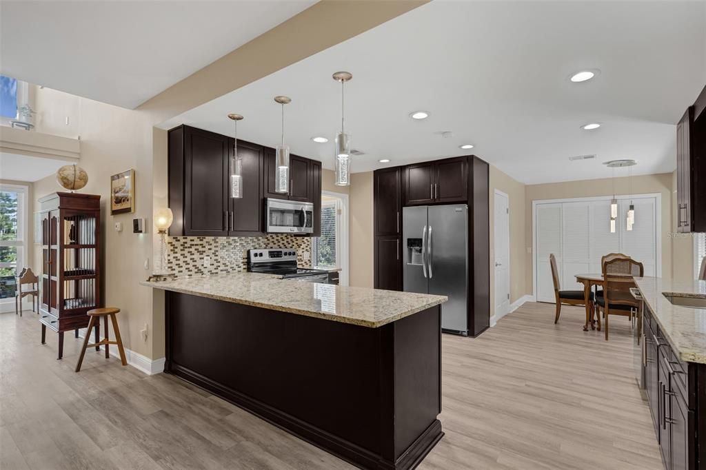 Dining room, Interior, Kitchen, Pendant Lights, Recessed Lighting, Stainless Steel Appliances, Wood Texture Flooring