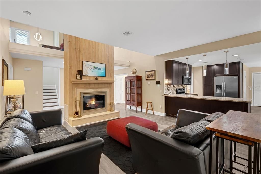 Fireplace, Interior, Kitchen, Living room, Pendant Lights, Recessed Lighting, Stainless Steel Appliances, Wood Texture Flooring, Wooden Walls