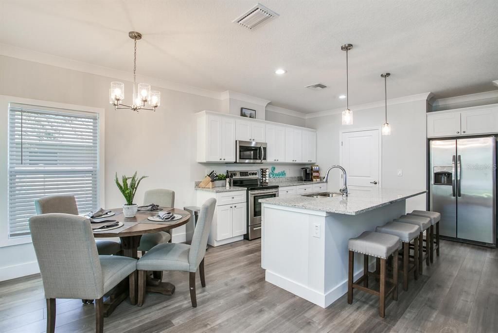 Chandelier, Dining room, Interior, Kitchen, Pendant Lights, Recessed Lighting, Stainless Steel Appliances, Wood Texture Flooring
