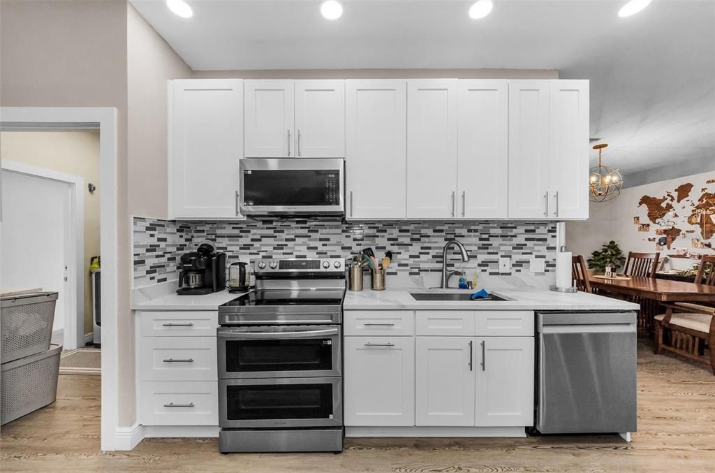 Chandelier, Dining room, Interior, Kitchen, Recessed Lighting, Stainless Steel Appliances, Wood Texture Flooring