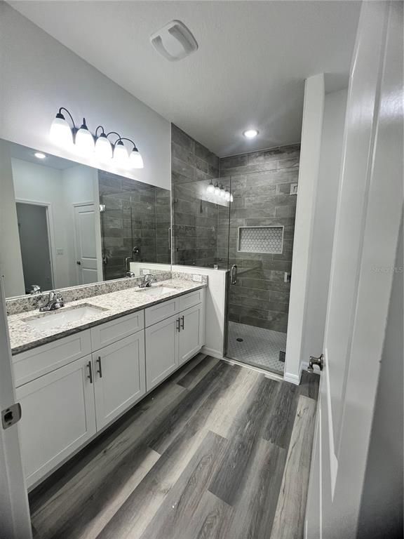 Bathroom, Dual Sink Vanities, Glass Shower, Interior, Recessed Lighting, Wood Texture Flooring