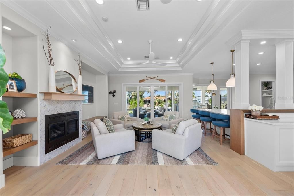 Dining room, Fireplace, Interior, Living room, Pendant Lights, Recessed Lighting, Wood Texture Flooring