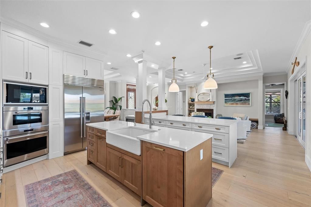 Fireplace, Interior, Kitchen, Living room, Pendant Lights, Recessed Lighting, Stainless Steel Appliances, Wood Texture Flooring