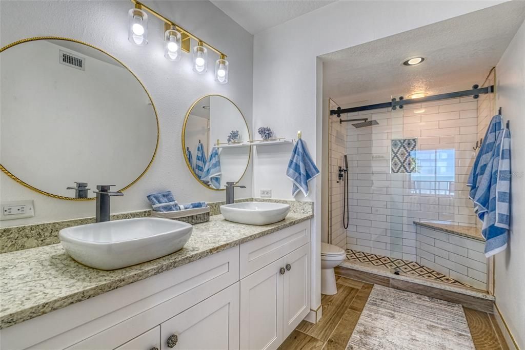 Bathroom, Dual Sink Vanities, Glass Shower, Interior, Recessed Lighting, Wood Texture Flooring