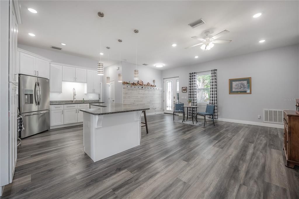 Dining room, Interior, Kitchen, Pendant Lights, Recessed Lighting, Stainless Steel Appliances, Wood Texture Flooring