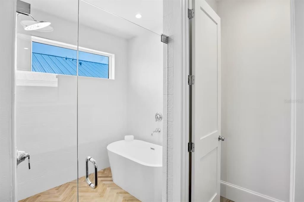 Bathroom, Free Standing Baths, Glass Shower, Interior, Pendant Lights, Recessed Lighting, Wood Texture Flooring