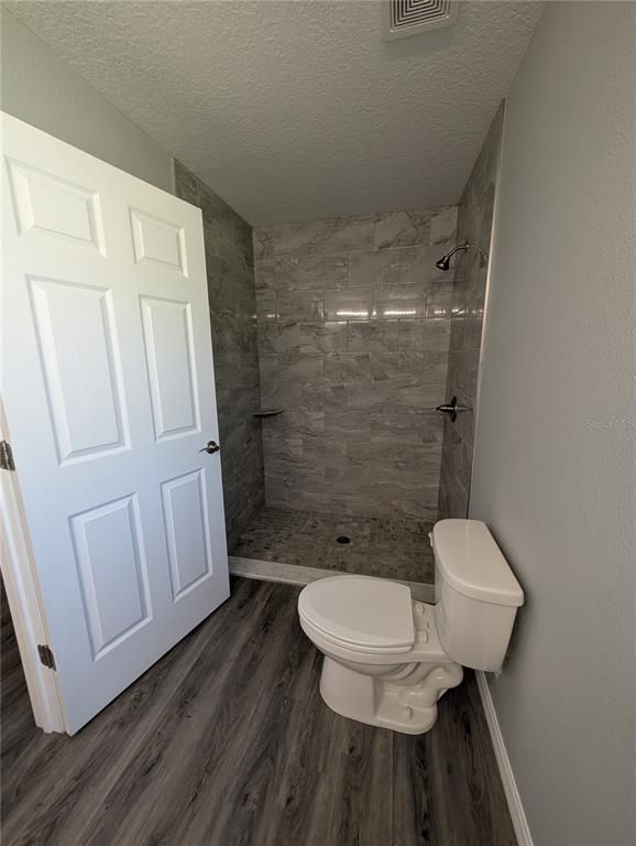 Bathroom, Glass Shower, Interior, Marble Walls, Wood Texture Flooring