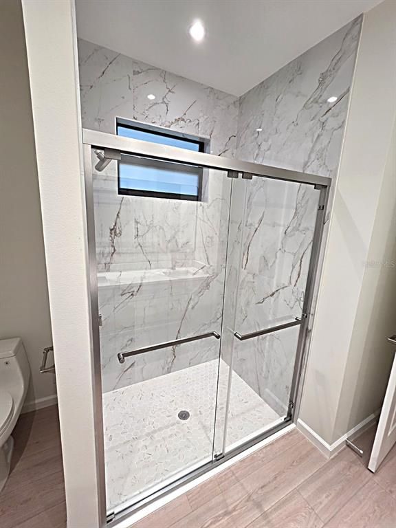 Bathroom, Glass Shower, Interior, Marble Walls, Recessed Lighting, Wood Texture Flooring