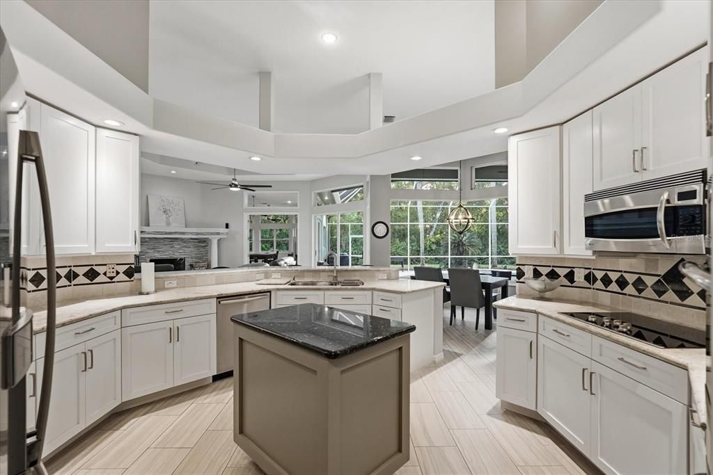 Dining room, Fireplace, Interior, Kitchen, Recessed Lighting, Stainless Steel Appliances, Wood Texture Flooring