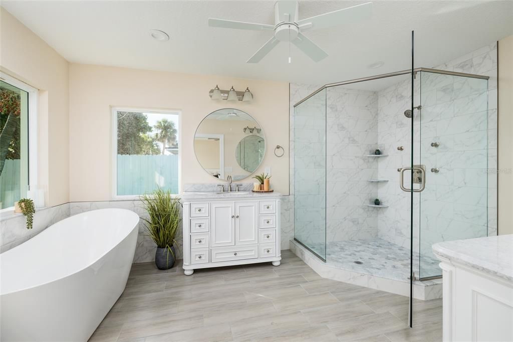 Bathroom, Free Standing Baths, Glass Shower, Interior, Marble Walls, Recessed Lighting, Wood Texture Flooring