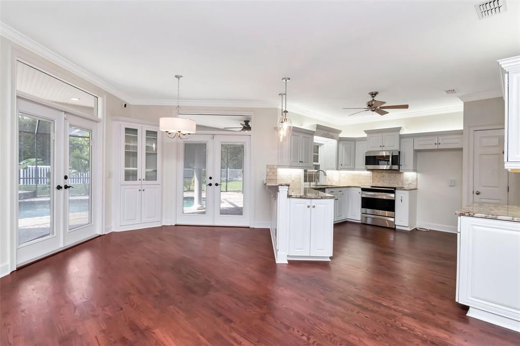 Empty room, Interior, Kitchen, Pendant Lights, Recessed Lighting, Stainless Steel Appliances, Wood Texture Flooring