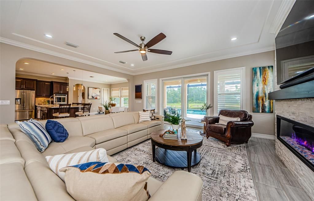 Fireplace, Interior, Kitchen, Living room, Pendant Lights, Recessed Lighting, Stainless Steel Appliances, Stone Walls, Wood Texture Flooring