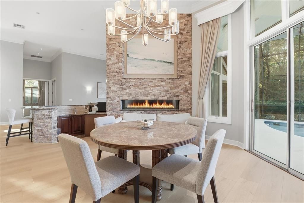 Chandelier, Dining room, Fireplace, Interior, Recessed Lighting, Stone Walls, Wood Texture Flooring