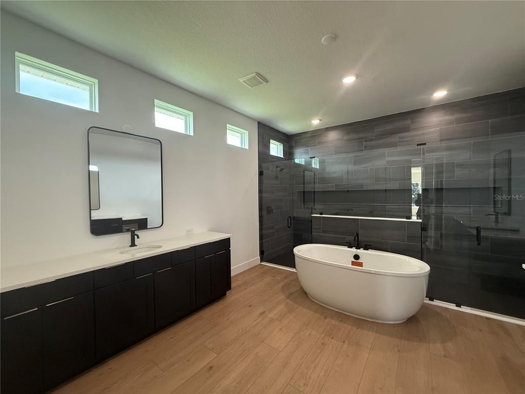Bathroom, Dual Sink Vanities, Free Standing Baths, Glass Shower, Interior, Recessed Lighting, Wood Texture Flooring