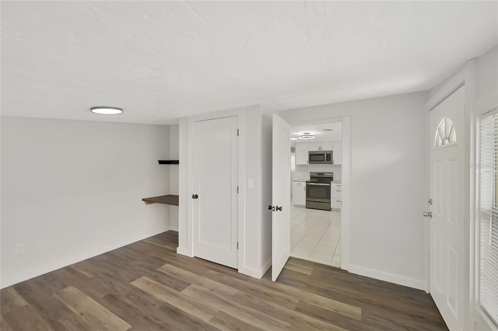Empty room, Interior, Kitchen, Recessed Lighting, Stainless Steel Appliances, Wood Texture Flooring