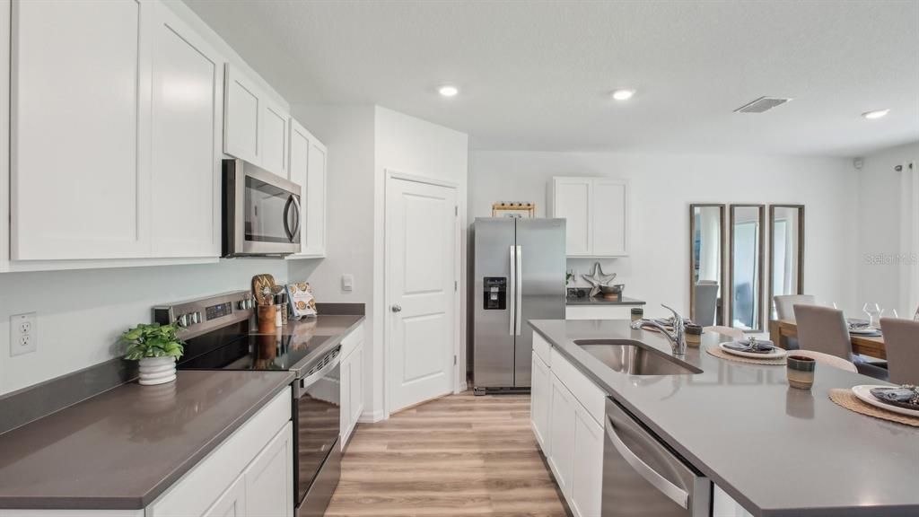Dining room, Interior, Kitchen, Recessed Lighting, Stainless Steel Appliances, Wood Texture Flooring