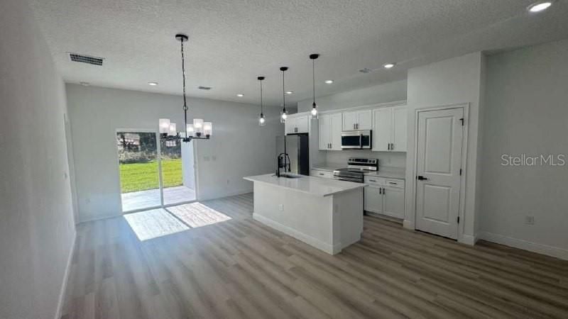 Chandelier, Interior, Kitchen, Pendant Lights, Recessed Lighting, Stainless Steel Appliances, Wood Texture Flooring