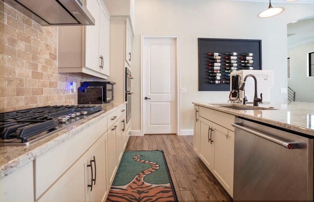 Interior, Kitchen, Pendant Lights, Recessed Lighting, Stainless Steel Appliances, Stone Walls, Wood Texture Flooring