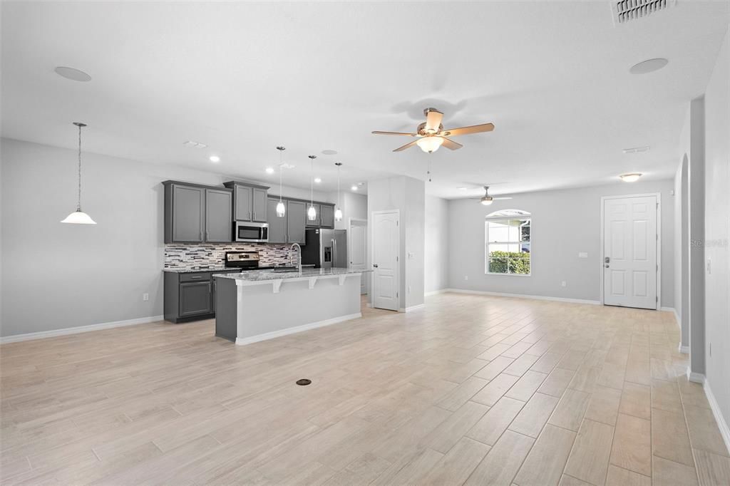 Empty room, Interior, Kitchen, Pendant Lights, Recessed Lighting, Stainless Steel Appliances, Wood Texture Flooring