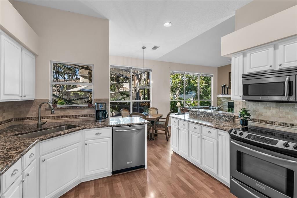 Chandelier, Dining room, Interior, Kitchen, Pendant Lights, Recessed Lighting, Stainless Steel Appliances, Wood Texture Flooring