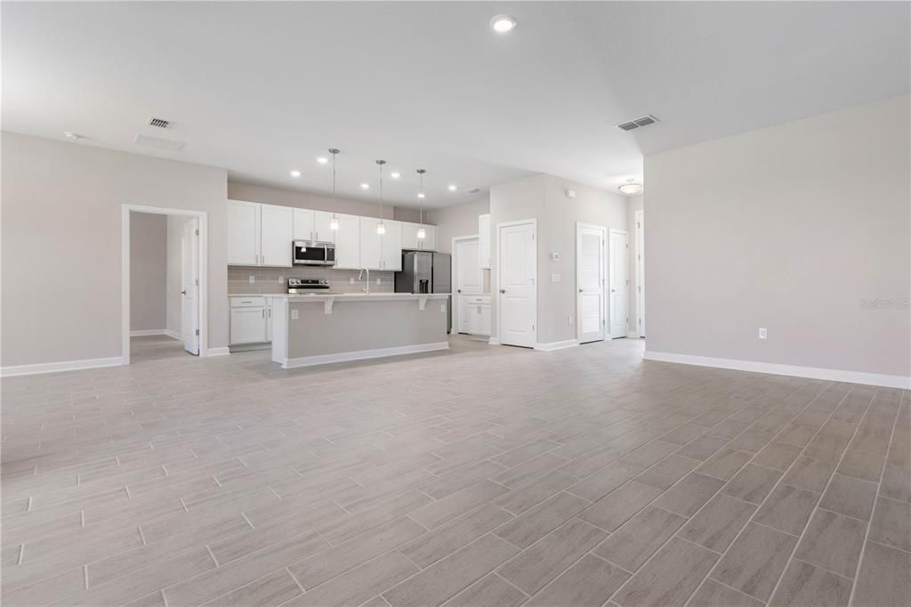 Empty room, Interior, Kitchen, Pendant Lights, Recessed Lighting, Stainless Steel Appliances, Wood Texture Flooring